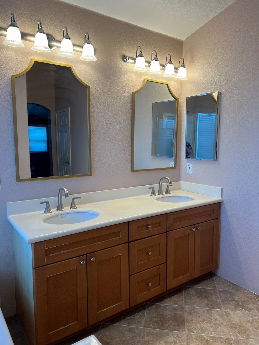 a bathroom with two sinks and a lot of mirrors
